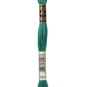 May include: A spool of DMC embroidery floss in shade 3814, a deep green colour. The spool is labelled with the DMC logo and the number 25, indicating the length of the floss. The barcode and number 3814 are also visible on the label.