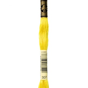 May include: A spool of DMC embroidery floss in colour 307, a bright yellow. The spool is labelled with the DMC logo and the colour number.