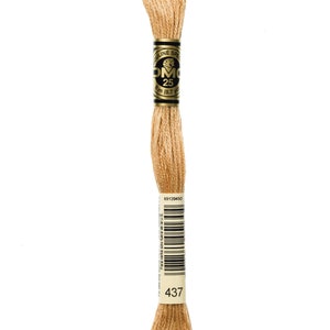 May include: A light tan spool of DMC 25 embroidery thread. The label shows "DMC 25" and "8 m (8.7 yds)". The number "437" is printed on the label. Suitable for cross-stitch, embroidery, and other needlework crafts.