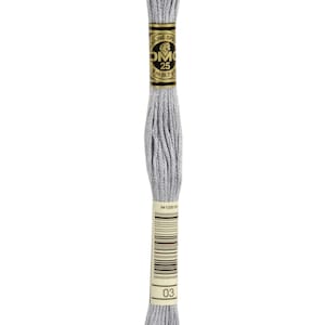 May include: A skein of DMC embroidery floss in colour 03, a light grey. The floss is wound around a cardboard spool with a gold label that reads "DMC 25 8 m (8.7 yd)".