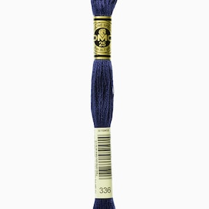 May include: A spool of DMC embroidery floss in colour 336, a deep blue shade. The spool is labelled with the DMC logo and the length of the floss, 8.7 yards (3 metres).