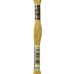 May include: A spool of DMC embroidery floss in colour 834, a light yellow shade. The spool is labelled with the DMC logo, the colour number, and the length of the floss in metres and yards.