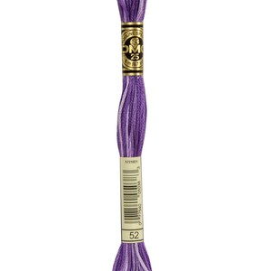 May include: DMC embroidery floss in colour 52, a purple and white variegated thread. The floss is wound on a card with the DMC logo and the colour number.