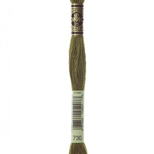 May include: A skein of DMC embroidery floss in colour 730, a muted olive green. The floss is wound on a white card with the DMC logo and the colour number 730 printed on it. The card also has a barcode and the text "2115027".