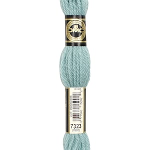 May include: A skein of DMC tapestry wool in a light blue colour. The skein is labelled with the DMC logo and the colour number 7323 (7692).