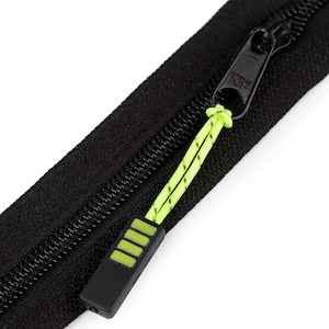 Könnte beinhalten: Schwarzer Reißverschluss mit einem grünen Zipper und einem schwarzen Schieber mit der Aufschrift "TOP".