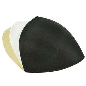 Könnte beinhalten: Drei BH-Cups in Beige, Weiß und Schwarz. Die Einsätze sind dreieckig und aus glattem Stoff gefertigt. Der schwarze Einsatz ist der größte, gefolgt von den weißen und beigen Einsätzen. Sie sind zur Formgebung und Unterstützung konzipiert.