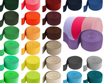 May include: A collection of colorful elastic bandages in various shades, including green, orange, yellow, pink, and blue. The bandages are rolled up and ready for use. Ideal for sports and medical applications.