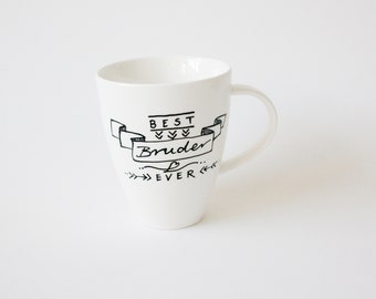 May include: White ceramic mug with a black hand-drawn design. The mug features the text "BEST Bruder EVER" in a banner, with decorative arrows and a heart. The mug has a curved handle and a tapered shape.