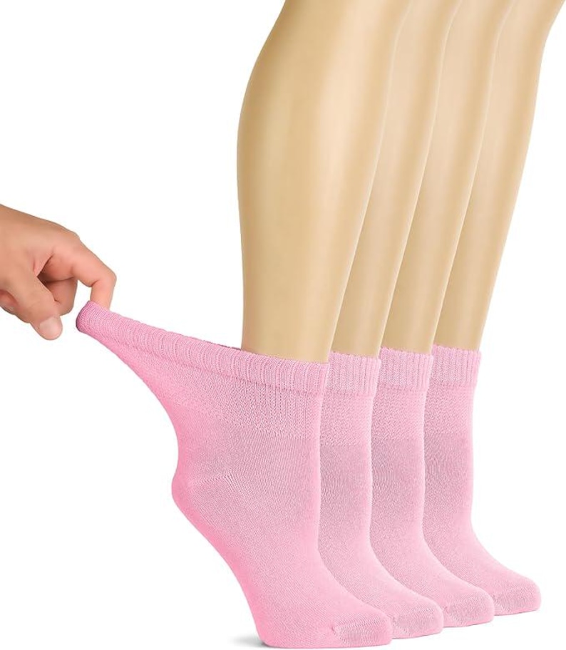May include: A set of four light pink ankle socks featuring a ribbed cuff design. The socks are shown in a row, with one sock being pulled slightly to demonstrate the stretch and texture of the fabric. The material appears soft and knit.