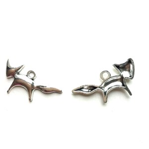 May include: Two silver fox charms with a simple, stylized design. The charms are perfect for adding a touch of whimsy to jewelry or crafts.