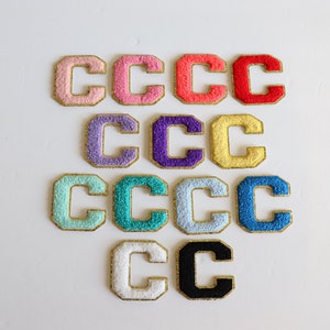 May include: Assortment of 12 felt letter patches in various colors, each with a gold outline. The letter is "C" in all patches.