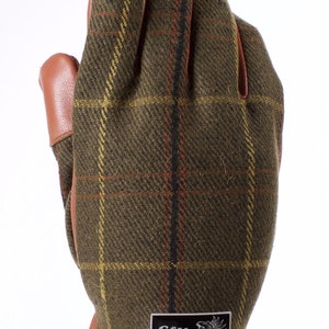 May include: Green, brown, and red plaid leather gloves with a brown leather cuff and a silver patch that says "Elite Styling Couture California".