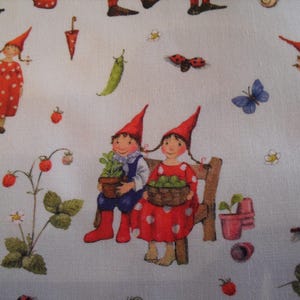 May include: White fabric with a whimsical garden scene. Features illustrations of gnomes, strawberries, butterflies, ladybugs, and other garden elements. Gnomes wear red hats and dresses with white polka dots. A charming, playful design.