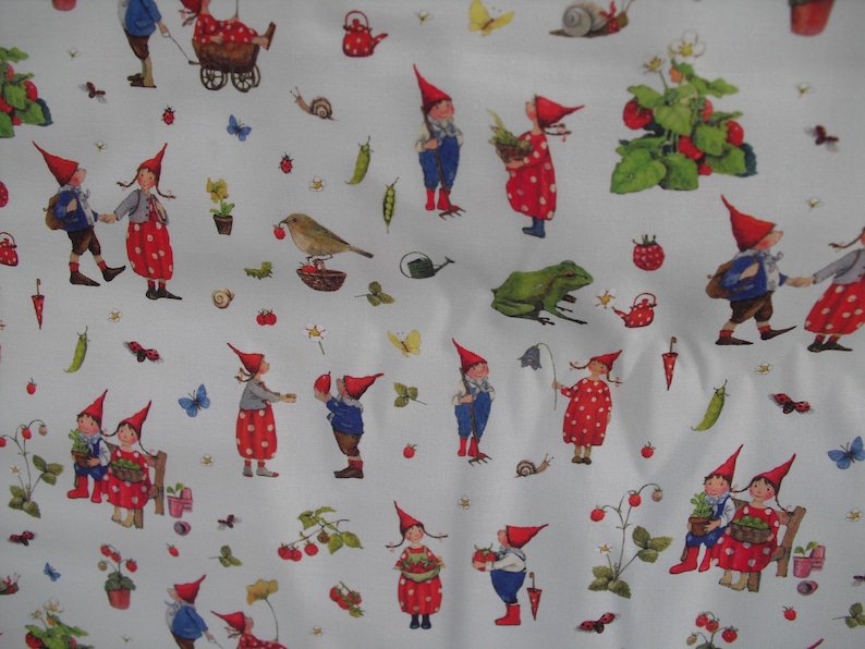 May include: White fabric with a repeating pattern of gnomes in red hats and polka-dot dresses, carrying baskets and interacting with strawberries, butterflies, and other garden elements. The gnomes are depicted in various poses.