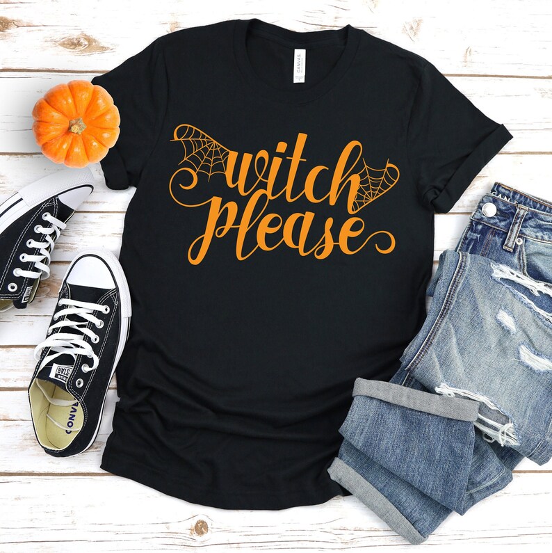 May include: Black t-shirt with the text "Witch Please" in orange with a spiderweb design on either side of the text.