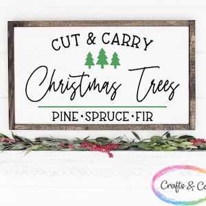 May include: A wooden sign with the text "Cut & Carry Christmas Trees" and the words "Pine, Spruce, Fir" underneath. The sign has a green border and three green Christmas trees are depicted above the text.