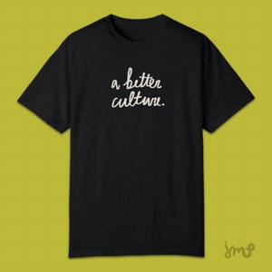 May include: Black t-shirt with the text "a better culture." written in white cursive.