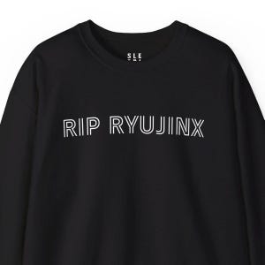 May include: Black long-sleeve sweatshirt with white text that reads "RIP RYUJINX".