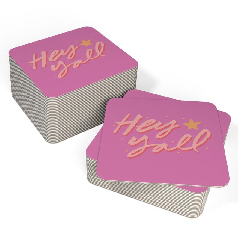 May include: A stack of pink square coasters with the text "Hey yall" in orange lettering and a small yellow star.