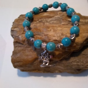 TURQUOISE BRACELET ACCENTED With Tibetan Silver Beads And A Chinese Character As A Charm Makes A Very Striking Homemade Piece Of Jewelry
