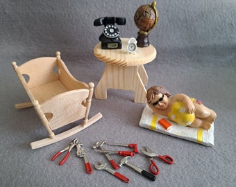 Elf world, miniatures, round wooden table, natural wood cradle, telephone, globe, alarm clock, woman on towel, tool set