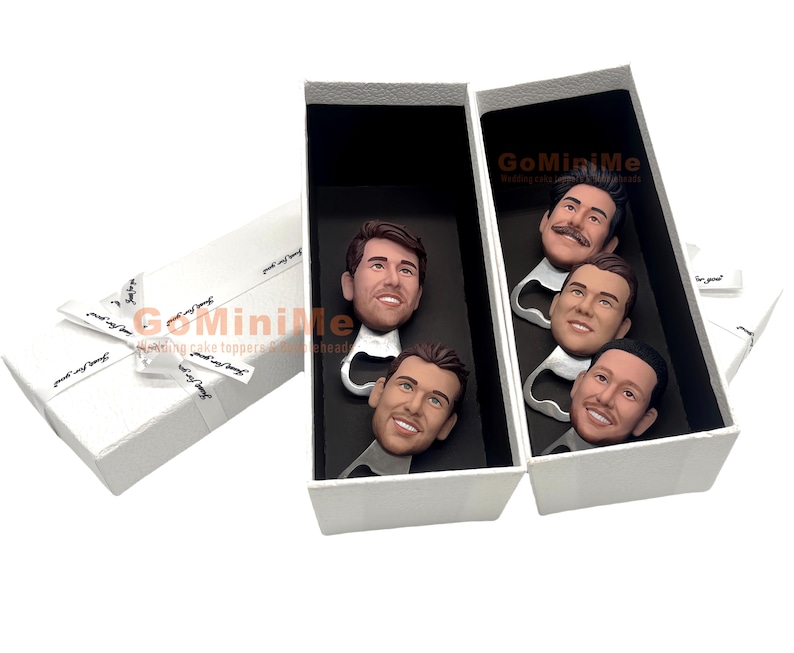 May include: A set of four bottle openers with personalized faces. The bottle openers are in a white box with the text "GoMiniMe" printed on the side.