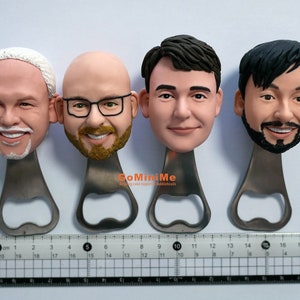 May include: Four personalized bottle openers with different faces sculpted on the top. The bottle openers are made of metal and have a silver finish. The faces are all smiling and have different hairstyles. The bottle openers are arranged in a row on a white surface.