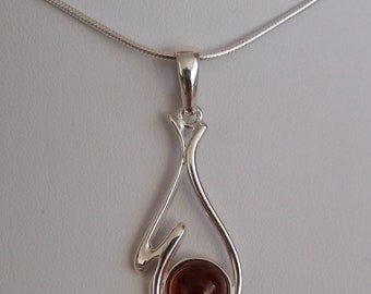 Silver pendant with amber