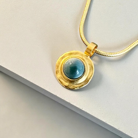 Ebb and Flow Necklace Baltic Gold Blue - Snake chain 22K matt gold plated with round pendant with blue glass stone and silver leaf