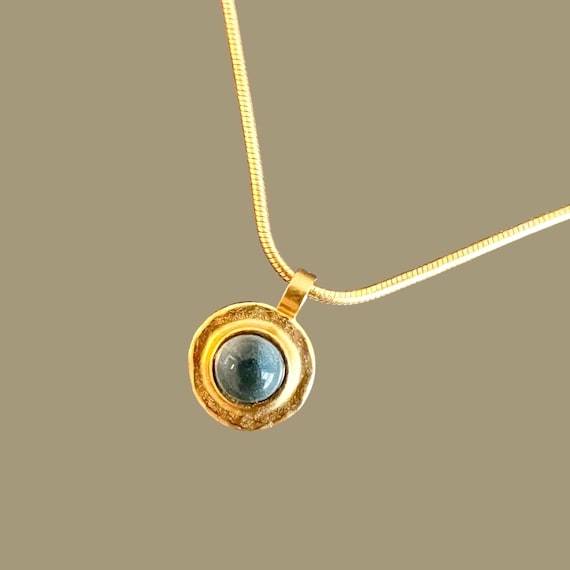 Ebb and Flow Necklace Baltic Gold Blue - Snake chain 22K matt gold plated with round pendant with blue glass stone and silver leaf
