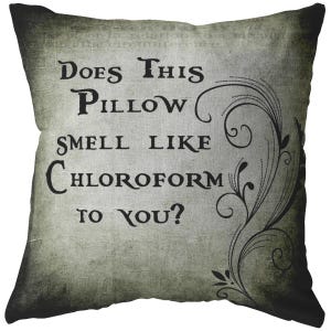 May include: A green and black throw pillow with a vintage design and the text "Does this pillow smell like chloroform to you?"