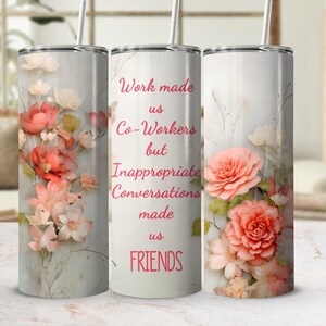 May include: A cylindrical stainless steel tumbler with a straw, featuring a light background decorated with soft pink and peach floral illustrations and the red text: Work made us Co-Workers but Inappropriate Conversations made us FRIENDS.