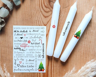 May include: Three white Advent candles with festive decorations, including a red ornament and a Christmas tree with gifts. A small card with holiday greetings and text is also present, all arranged on a wooden surface.