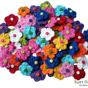 Könnte beinhalten: Eine Sammlung bunter gehäkelter Blumen mit Knopfmitten. Die Blumen sind in verschiedenen Farbtönen von Rosa, Blau, Grün, Gelb, Orange und Weiß.