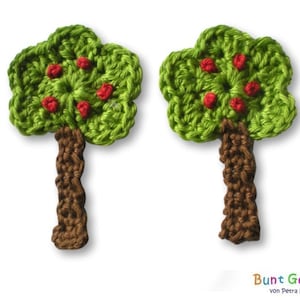 Könnte beinhalten: Zwei grüne gehäkelte Apfelbäume mit braunen gehäkelten Stämmen. Jeder Baum hat rote gehäkelte Äpfel.