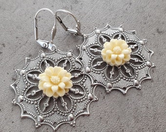 Beautiful and delicate filigree earrings with antique silver floral design and a resin flower