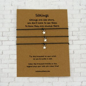 May include: Three black string bracelets with silver star charms. The card reads "Siblings, siblings are like stars, you don't have to see them to know they are always there. Tie this bracelet to your wrist, as you do make a wish. When the bracelet breaks in two, legend says your wish will come true! salemwishes.com"