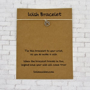 May include: A brown card with the text "Wish Bracelet" printed on it. The card has instructions on how to make a wish with the bracelet. The text reads: "Tie this bracelet to your wrist, as you do make a wish. When the bracelet breaks in two, legend says your wish will come true! Salemwishes.com"