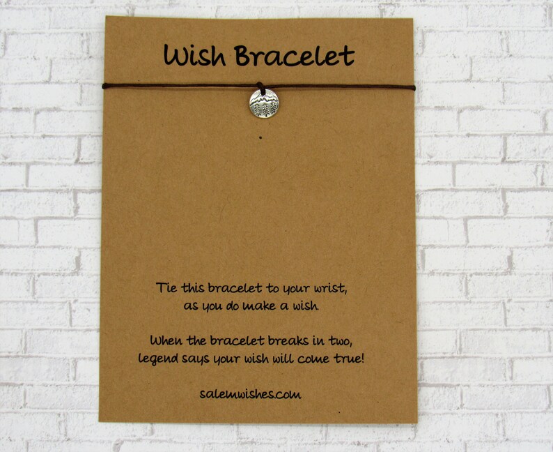 May include: A brown card with the text "Wish Bracelet" printed on it. The card has instructions on how to use the bracelet: "Tie this bracelet to your wrist, as you do make a wish. When the bracelet breaks in two, legend says your wish will come true!" The card also includes the website address "salemwishes.com".