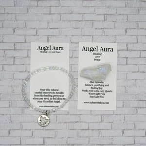 May include: A white crystal bracelet with an angel charm. The card reads "Angel Aura Healing, Love and Peace" and lists the benefits of the crystal. The card also includes the website address www.salemwishes.com.