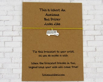 May include: A brown card with a yellow string tied around it. The card has the text "This Is What An Awesome Bus Driver Looks Like" and a small silver charm of a school bus. The string is tied to the charm. The card also has the text "Tie this bracelet to your wrist, as you do make a wish. When the bracelet breaks in two, legend says your wish will come true! Salemwishes.com"