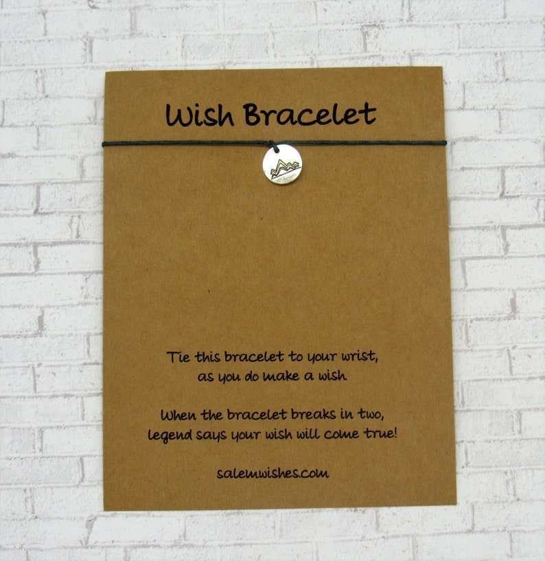 May include: A brown card with the text "Wish Bracelet" printed on it. The card has instructions for making a wish and tying a bracelet. The text reads: "Tie this bracelet to your wrist, as you do make a wish. When the bracelet breaks in two, legend says your wish will come true! salemwishes.com"