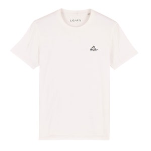 May include: White t-shirt with a small embroidered design of two birds holding a bottle of wine. The text "LIGARTI" is printed on the shirt.