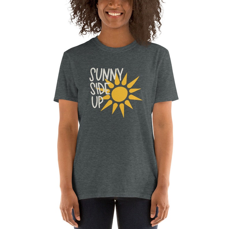 May include: A heather grey t-shirt with a yellow sun graphic and the text "SUNNY SIDE UP" in white.
