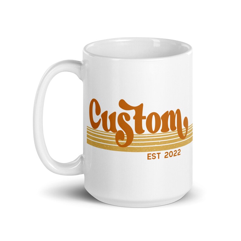 May include: White ceramic mug with a brown and orange design that says "Custom EST 2022".