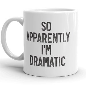Könnte beinhalten: Weiße Keramik-Kaffeetasse mit schwarzem Text, der "So Apparently I'm Dramatic" lautet.