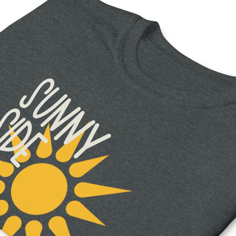 May include: A dark gray t-shirt with a yellow sun and the text "Sunny Side" in white.