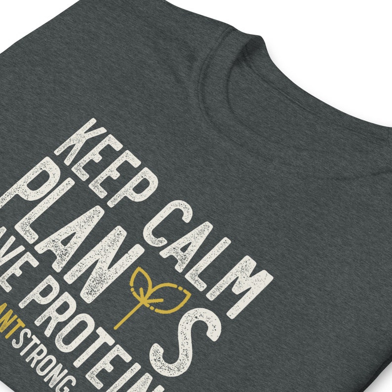 May include: A dark grey t-shirt with the text "Keep Calm Plants Have Protein" in white with a small green plant icon. The text is distressed and has a vintage look.