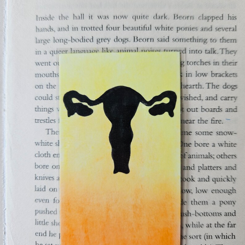 May include: A black silhouette of a female reproductive system on a yellow to orange gradient background.